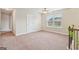 Bright loft area featuring carpet flooring, neutral walls, a ceiling fan and natural light at 12323 Styron Dr, Hampton, GA 30228
