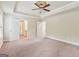 Spacious main bedroom with trey ceilings, carpet flooring, and a view to the bathroom and walk-in closet at 12323 Styron Dr, Hampton, GA 30228