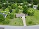 Aerial view of a home with mature trees, a long driveway, and a red storage shed at 130 Belmont Trl, Covington, GA 30016