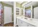 Bathroom featuring double sinks, white cabinetry, and a well-lit mirror, with a decorative shower curtain at 130 Belmont Trl, Covington, GA 30016