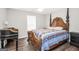 Bedroom features a four poster bed frame, dark wood flooring, and a large window at 130 Belmont Trl, Covington, GA 30016