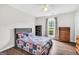 Cozy bedroom featuring hardwood floors, a large window, and patriotic themed quilt at 130 Belmont Trl, Covington, GA 30016