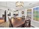 Open dining area connecting to the kitchen and featuring a wood table and modern lighting at 130 Belmont Trl, Covington, GA 30016
