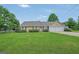 Charming single-story home featuring a manicured lawn, trimmed hedges, and a two-car garage at 130 Belmont Trl, Covington, GA 30016