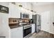 Contemporary kitchen featuring stainless steel appliances, including a range, microwave, and refrigerator, complemented by stylish countertops at 130 Belmont Trl, Covington, GA 30016