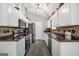 Galley kitchen featuring white cabinets, stainless steel appliances, and modern countertops with wood-look flooring at 130 Belmont Trl, Covington, GA 30016