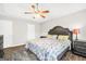 Spacious main bedroom showcasing a ceiling fan, trey ceiling, hardwood floors, and ample natural light at 130 Belmont Trl, Covington, GA 30016
