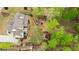 Aerial view of a home featuring a beautiful backyard with a fire pit and lush landscaping at 157 Waterlace Way, Fayetteville, GA 30215