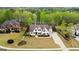 Aerial view of an elegant home with a manicured lawn and mature trees in a serene setting at 157 Waterlace Way, Fayetteville, GA 30215