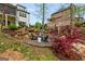 Beautiful backyard firepit seating area with stone accents and mature trees, perfect for outdoor gatherings at 157 Waterlace Way, Fayetteville, GA 30215