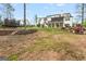 Wide backyard view of the home, trampolines, landscaping, and more, perfect for entertaining guests at 157 Waterlace Way, Fayetteville, GA 30215