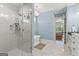 Bright bathroom features a glass shower, soaking tub and marble floors at 157 Waterlace Way, Fayetteville, GA 30215