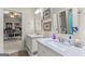 Bathroom with double sinks, framed mirrors, and an open doorway at 157 Waterlace Way, Fayetteville, GA 30215