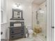 Stylish bathroom featuring unique sink vanity, glass shower with bench, and tiled floors at 157 Waterlace Way, Fayetteville, GA 30215