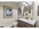 Well-lit powder room featuring modern fixtures, artistic decor, and elegant finishes at 157 Waterlace Way, Fayetteville, GA 30215