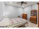 Simple bedroom with vintage wooden furniture and bright, patterned quilt at 157 Waterlace Way, Fayetteville, GA 30215