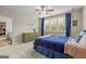 Bedroom with a ceiling fan, plantation shutters, and blue accents at 157 Waterlace Way, Fayetteville, GA 30215