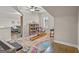Bonus room with dark hardwood floors and a brightly colored rug at 157 Waterlace Way, Fayetteville, GA 30215