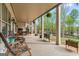 Spacious covered patio with outdoor seating, charming decor, and a serene backyard view at 157 Waterlace Way, Fayetteville, GA 30215