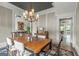 Spacious dining room featuring a wooden table with seating for six and stylish chandelier at 157 Waterlace Way, Fayetteville, GA 30215