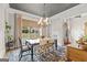 Elegant dining room with stylish chandelier, large window, and patterned rug, perfect for Gathering gatherings at 157 Waterlace Way, Fayetteville, GA 30215