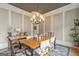 Bright dining room with large table, chandelier, and classic wood accents for elegant dining at 157 Waterlace Way, Fayetteville, GA 30215