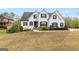 Charming exterior of a white two-story home with dark shutters and landscaped front yard at 157 Waterlace Way, Fayetteville, GA 30215