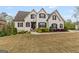 Stately white home with dark shutters, complemented by manicured landscaping and a sprawling lawn at 157 Waterlace Way, Fayetteville, GA 30215