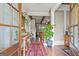 Inviting foyer showcasing hardwood floors, a stylish rug, and an array of potted plants at 157 Waterlace Way, Fayetteville, GA 30215
