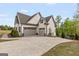 Spacious three-car garage with ample parking space and well-maintained surroundings at 157 Waterlace Way, Fayetteville, GA 30215