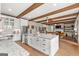 Bright kitchen with hardwood floors, ceiling beams, and an island overlooking the living room at 157 Waterlace Way, Fayetteville, GA 30215
