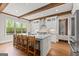 Bright kitchen featuring hardwood floors, ceiling beams, and a large island with seating at 157 Waterlace Way, Fayetteville, GA 30215
