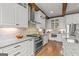 Bright kitchen featuring hardwood floors, white cabinets, and stainless steel appliances at 157 Waterlace Way, Fayetteville, GA 30215