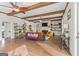 Open-concept living room with hardwood floors, ceiling beams, and a fireplace at 157 Waterlace Way, Fayetteville, GA 30215