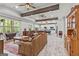 Open concept living room with beautiful beamed ceilings and luxury vinyl flooring at 157 Waterlace Way, Fayetteville, GA 30215