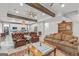 Open concept living room with beamed ceilings seamlessly connects to the updated kitchen at 157 Waterlace Way, Fayetteville, GA 30215