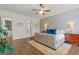 Spacious bedroom with hardwood floors, tufted bed, and ample natural light for a peaceful sanctuary at 157 Waterlace Way, Fayetteville, GA 30215