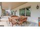 Covered patio with a large wood table and bench seating provides an ideal outdoor dining space at 157 Waterlace Way, Fayetteville, GA 30215