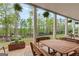 Covered patio with wood dining table and backyard views with lots of trees offer outdoor living at 157 Waterlace Way, Fayetteville, GA 30215