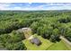 Aerial view shows house, outbuildings, and wooded surroundings, offering privacy and natural beauty at 3950 Chattahoochee Rd, Cumming, GA 30041