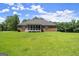 Lawn view of a single-Gathering home with a screened porch in a well-maintained yard at 3950 Chattahoochee Rd, Cumming, GA 30041