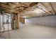 An unfinished basement space with concrete flooring, insulation, and utilities at 3950 Chattahoochee Rd, Cumming, GA 30041