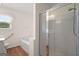 Bathroom with a shower, bathtub, toilet, and a bright window at 3950 Chattahoochee Rd, Cumming, GA 30041