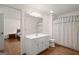 Bright bathroom with hardwood floors, a white vanity, and a decorative shower curtain at 3950 Chattahoochee Rd, Cumming, GA 30041