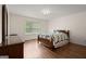 Inviting bedroom with hardwood floors, natural light, and a decorative quilt on the bed at 3950 Chattahoochee Rd, Cumming, GA 30041