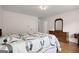 Comfortable bedroom with a wooden dresser and bedside table, a cozy quilt and hardwood flooring at 3950 Chattahoochee Rd, Cumming, GA 30041