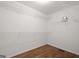 A walk in closet with custom shelving and wood floor at 3950 Chattahoochee Rd, Cumming, GA 30041