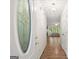 Inviting entryway featuring a decorative glass front door and hardwood floors, leading into a bright, airy living space at 3950 Chattahoochee Rd, Cumming, GA 30041