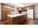 Well-lit kitchen with a central island, modern appliances, and lots of cabinet storage space at 3950 Chattahoochee Rd, Cumming, GA 30041