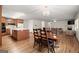 Large open kitchen and dining area showcasing hardwood floors, ample lighting and spacious layout at 3950 Chattahoochee Rd, Cumming, GA 30041